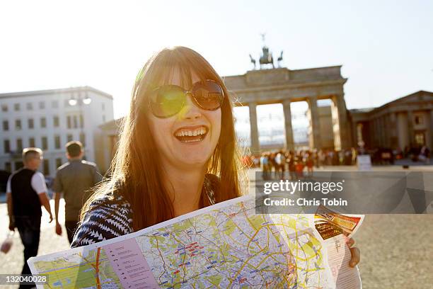 laughing girl with street map - berlin tourist stock pictures, royalty-free photos & images