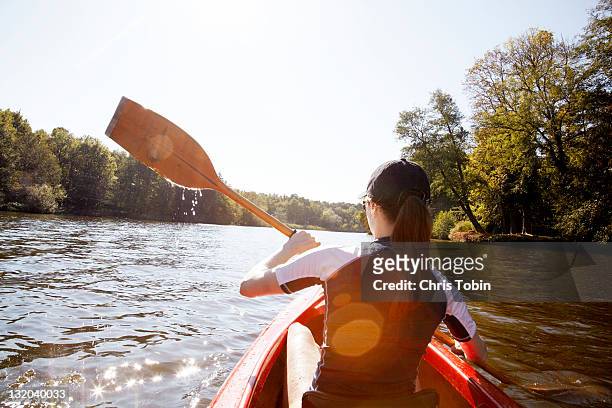 girl in canoe - boat rowing stock pictures, royalty-free photos & images