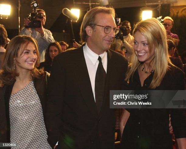 Actor Kevin Costner, center, his daughter Annie, left, and girlfriend Christine Baumgartner, right, arrive at the premiere of New Line Cinema''s...