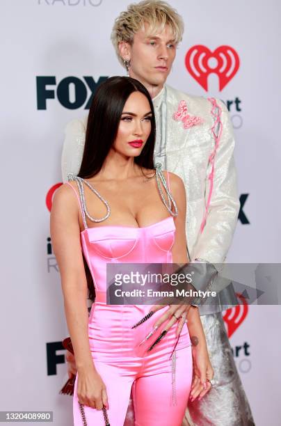 Megan Fox and Machine Gun Kelly attend the 2021 iHeartRadio Music Awards at The Dolby Theatre in Los Angeles, California, which was broadcast live on...