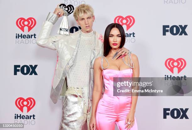 Machine Gun Kelly, winner of the Alternative Rock Album of the Year award for 'Tickets To My Downfall,’ and Megan Fox attend the 2021 iHeartRadio...