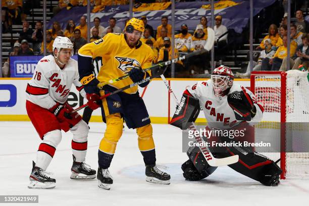 Yakov Trenin of the Nashville Predators tries to deflect a puck in front of goalie Alex Nedeljkovic of the Carolina Hurricanes during the first...