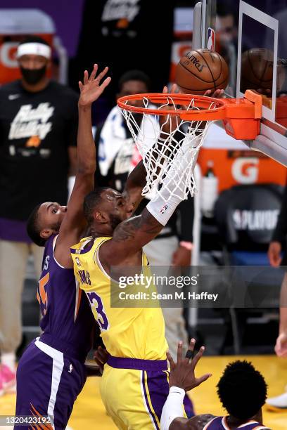 LeBron James of the Los Angeles Lakers drives past Mikal Bridges of the Phoenix Suns during the first half of Game Three of the Western Conference...