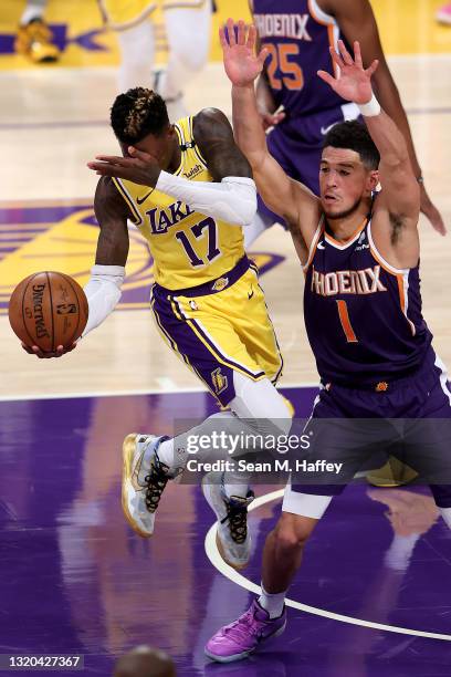 Dennis Schroder of the Los Angeles Lakers reacts after being poked in the eye by Devin Booker of the Phoenix Suns during the first half of Game Three...