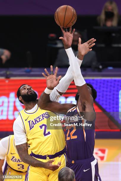 Andre Drummond of the Los Angeles Lakers tips off against Deandre Ayton of the Phoenix Suns during the first half of Game Three of the Western...