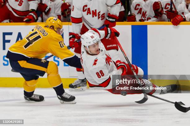 Mikael Granlund of the Nashville Predators trips Martin Necas of the Carolina Hurricanes during the second period in Game Six of the First Round of...