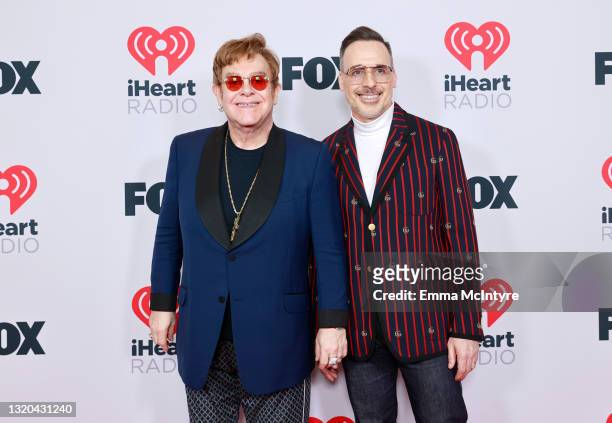 Honoree Elton John and David Furnish attend the 2021 iHeartRadio Music Awards at The Dolby Theatre in Los Angeles, California, which was broadcast...