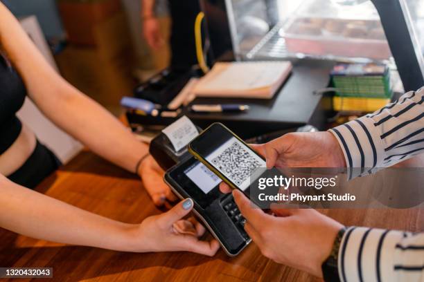demonstration of wireless payment via smartphone - digital store imagens e fotografias de stock