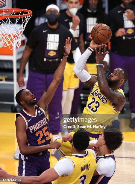 LeBron James of the Los Angeles Lakers makes takes a jump shot past the defense of Mikal Bridges of the Phoenix Suns during the second half of Game...