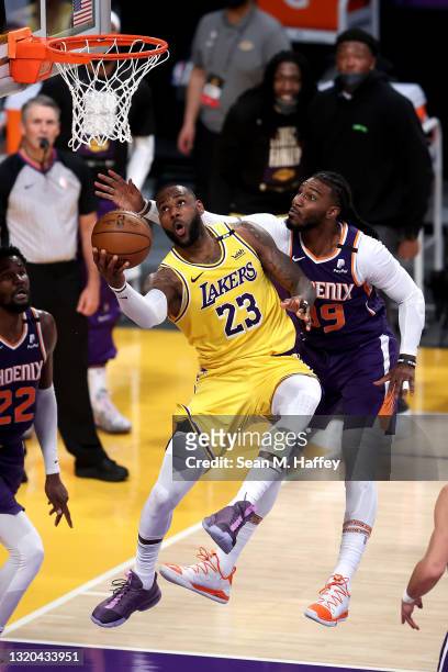 LeBron James of the Los Angeles Lakers makes a layup past the defense of Jae Crowder of the Phoenix Suns during the second half of Game Three of the...