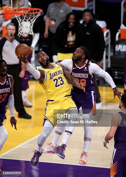 LeBron James of the Los Angeles Lakers makes a layup past the defense of Jae Crowder of the Phoenix Suns during the second half of Game Three of the...