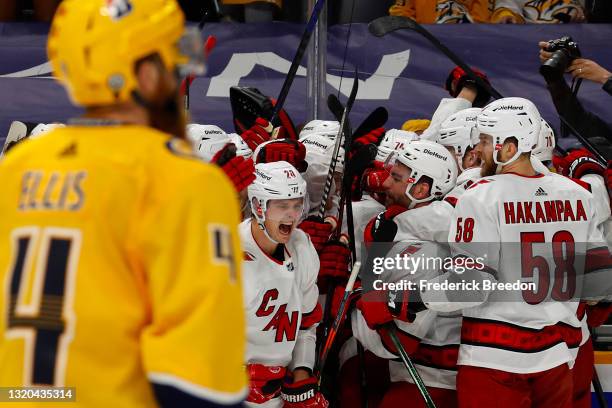 The Carolina Hurricanes celebrate after their 4-3 overtime victory against the Nashville Predators in Game Six of the First Round of the 2021 Stanley...