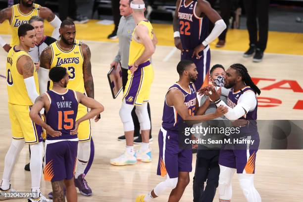 Mikal Bridges holds back Jae Crowder of the Phoenix Suns as he is assessed a technical foul and ejected from the game as LeBron James and Kyle Kuzma...