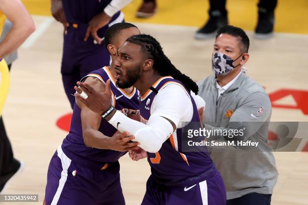 Mikal Bridges holds back Jae Crowder of the Phoenix Suns as he is assessed a technical foul and ejected from the game during the second half of Game...