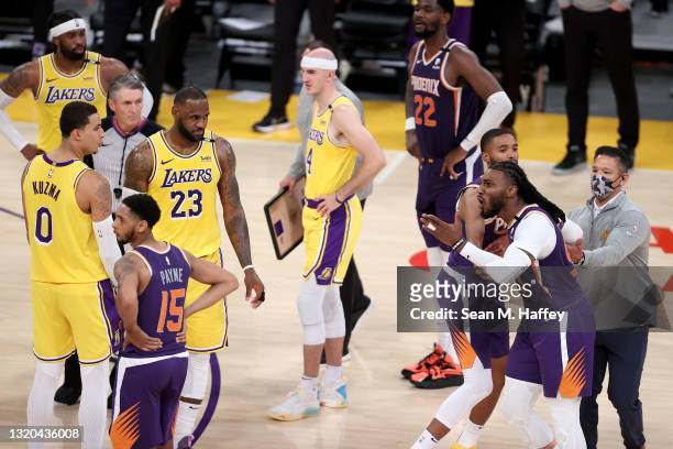 Mikal Bridges holds back Jae Crowder of the Phoenix Suns as he is assessed a technical foul and ejected from the game as LeBron James, Alex Caruso,...