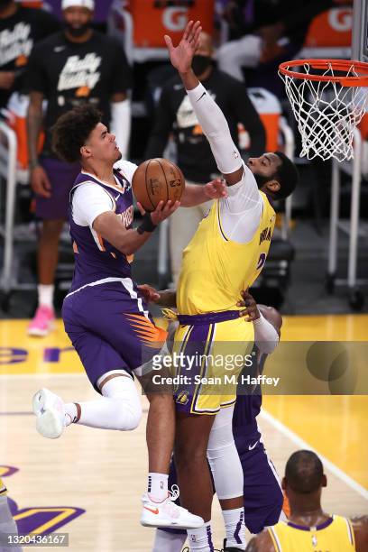 Cameron Johnson of the Phoenix Suns makes a layup past the defense of Andre Drummond of the Los Angeles Lakers during the second half of Game Three...