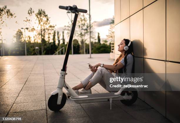 portrait of a woman with electric scooter - electric push scooter stock pictures, royalty-free photos & images