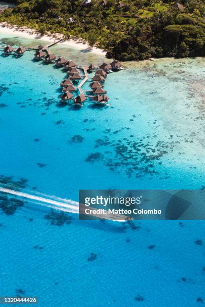 aerial of motorboat in the lagoon of bora bora, french polynesia - south pacific ocean stock pictures, royalty-free photos & images