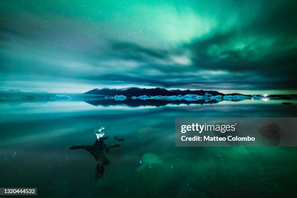 aurora borealis (northern lights) over glacial lagoon in iceland - jokulsarlon lagoon ストックフォトと画像