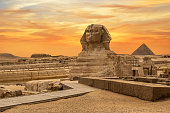 Landscape with Egyptian pyramids, Great Sphinx and silhouettes Ancient symbols and landmarks of Egypt for your travel concept to Africa in golden sunlight.