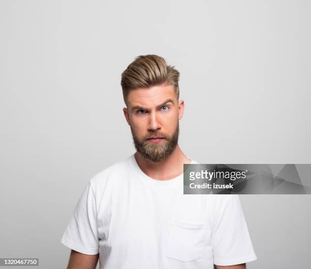 headshot of angry young man - suspicion stock pictures, royalty-free photos & images