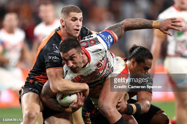 Paul Vaughan of the Dragons is tackled during the round 12 NRL match between the Wests Tigers and the St George Illawarra Dragons at Bankwest Stadium...