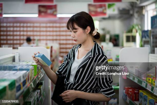 pharmacy - chinese young adults shopping stock pictures, royalty-free photos & images