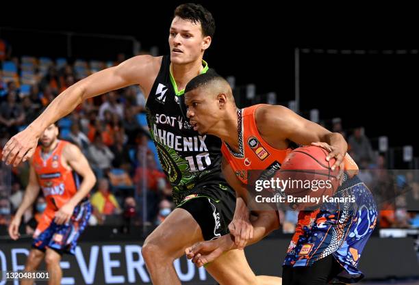 Scott Machado of the Taipans takes on the defence of Yannick Wetzell of the Phoenix during the round 20 NBL match between South East Melbourne...