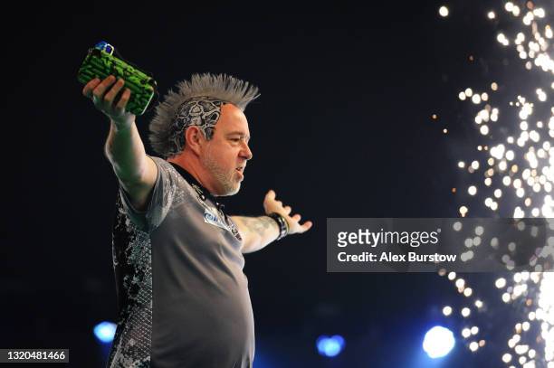 Peter Wright of Scotland interacts with the crowd as he walks out ahead of his match against Michael van Gerwen of The Netherlands during Night 16 of...
