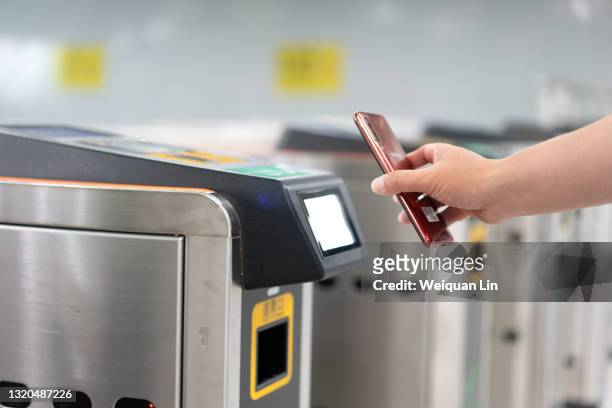 people who are using a smartphone qr code to scan into a subway station - shenzhen stock pictures, royalty-free photos & images