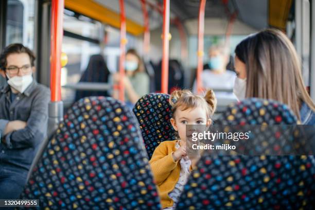 mother and daughter in public bus transport - kids sitting together in bus stock pictures, royalty-free photos & images