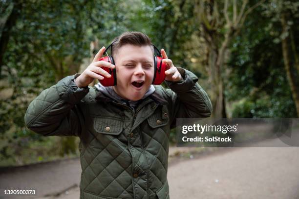 wearing protective ear defenders - senses stock pictures, royalty-free photos & images