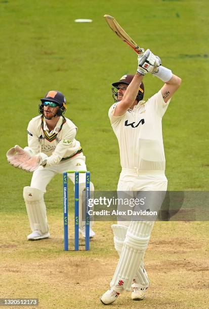 Rikki Clarke of Surrey hits out watched on by Jonathan Tattersall of Gloucestershire during Day Two of the LV= Insurance County Championship match...