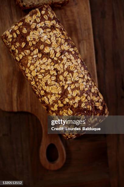 freshly baked traditional bread on wooden table - avena sativa stock pictures, royalty-free photos & images