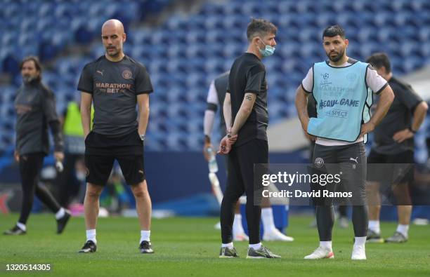 Sergio Aguero of Manchester City and Pep Guardiola, Manager of Manchester City looks on during the Manchester City FC Training Session ahead of the...