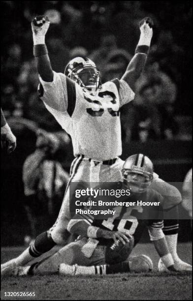 American football player Fred Strickland, of the Los Angeles Rams celebrates his sack of quarterback Joe Montana, of the San Francisco 49ers, during...