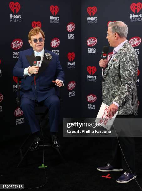 Honoree Elton John and Elvis Duran speak at the 2021 iHeartRadio Music Awards at The Dolby Theatre in Los Angeles, California, which was broadcast...