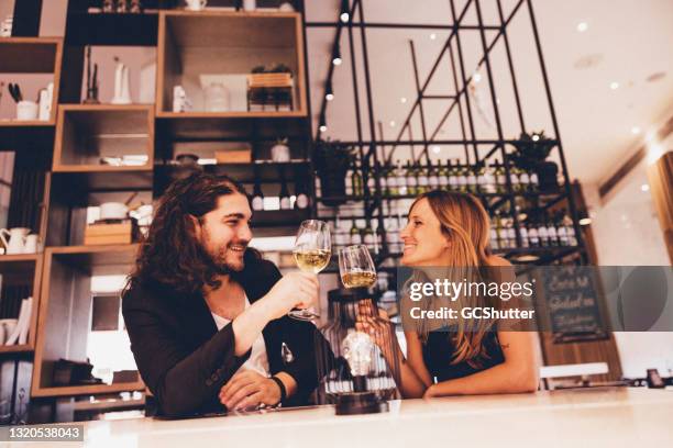 couple enjoying date night at a luxury restaurant - bar atmosphere stock pictures, royalty-free photos & images