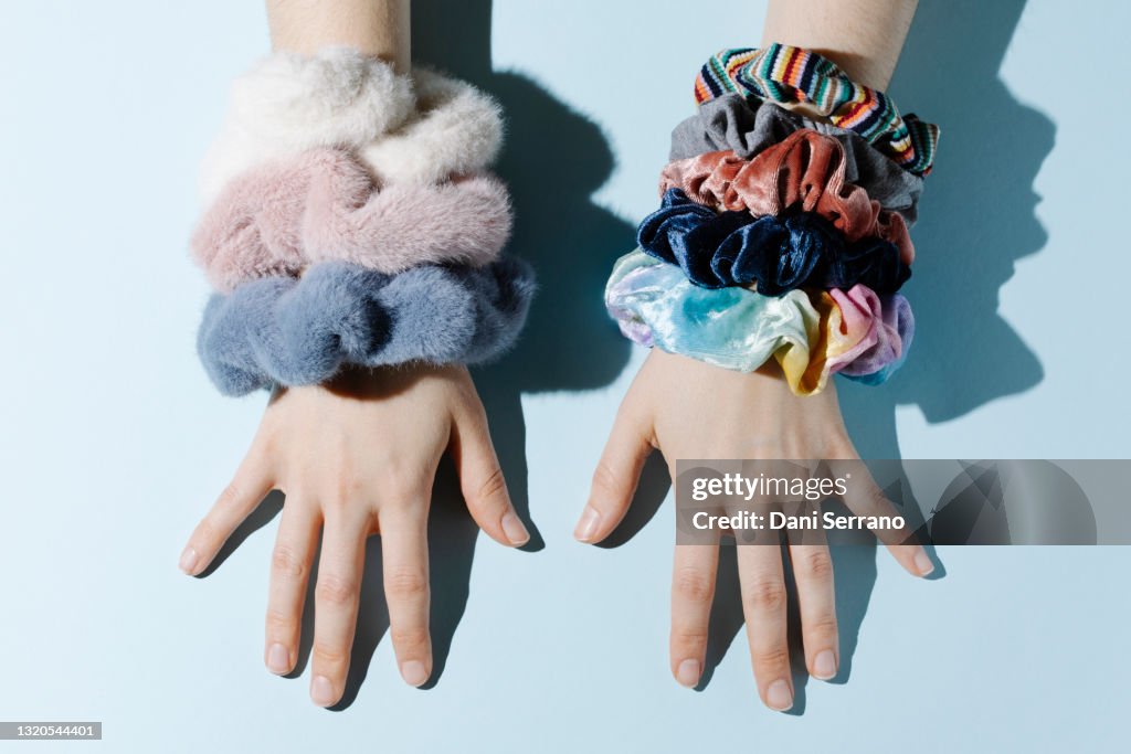 Woman with scrunchies on pastel background