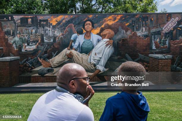 Nehemiah Frank , teaches his cousin David McIntye II of the Tulsa massacre, in the Greenwood district, on May 28, 2021 in Tulsa, Oklahoma. This year...