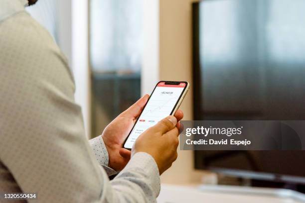 businessman looking at his bank's app on his mobile phone - cuenta de banco fotografías e imágenes de stock