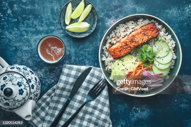 spicy salmon bowl with rice, carrots, cucumber and avocado - salmon steak stock pictures, royalty-free photos & images