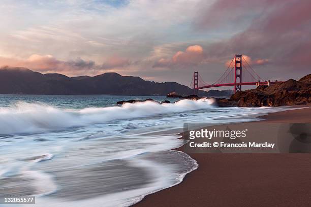 golden gate bridge at sunset - baker beach stock pictures, royalty-free photos & images