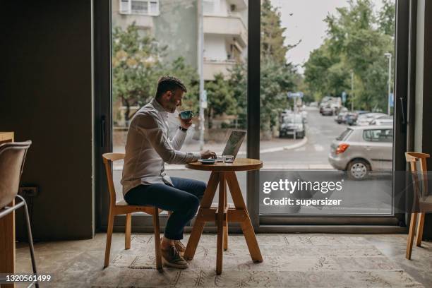 young attractive man in the coffee shop - free wifi stock pictures, royalty-free photos & images