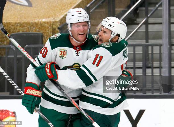 Ryan Suter and Zach Parise of the Minnesota Wild celebrate after Suter assisted Parise on a first-period goal against the Vegas Golden Knights in...