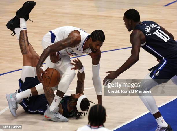 Paul George of the LA Clippers dribbles the ball against Willie Cauley-Stein of the Dallas Mavericks in the second quarter in game three of the...
