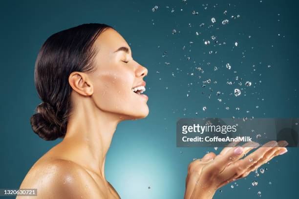 girl washes her face - washing face stock pictures, royalty-free photos & images