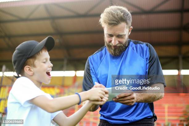 soccer player signing an autograph - athletic supporter stock pictures, royalty-free photos & images