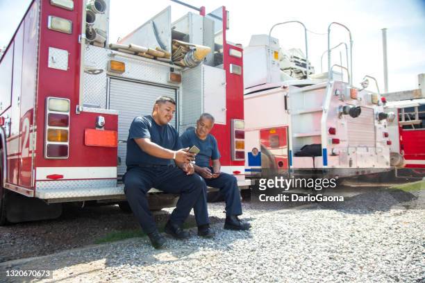 two firefighters at the station, taking a break