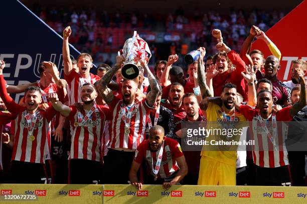 Pontus Jansson of Brentford lifts the Sky Bet Championship Play Off Trophy following victory in the Sky Bet Championship Play-off Final between...